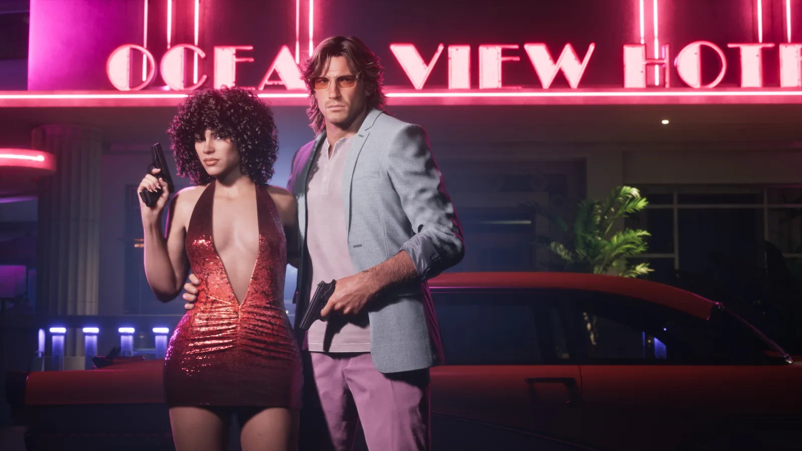 A woman in a red sequinned dress holding a pistol beside a man in a grey blazer and pink trousers also holding a pistol, standing in front of a red classic car under the pink neon sign of the Ocean View Hotel at night.
