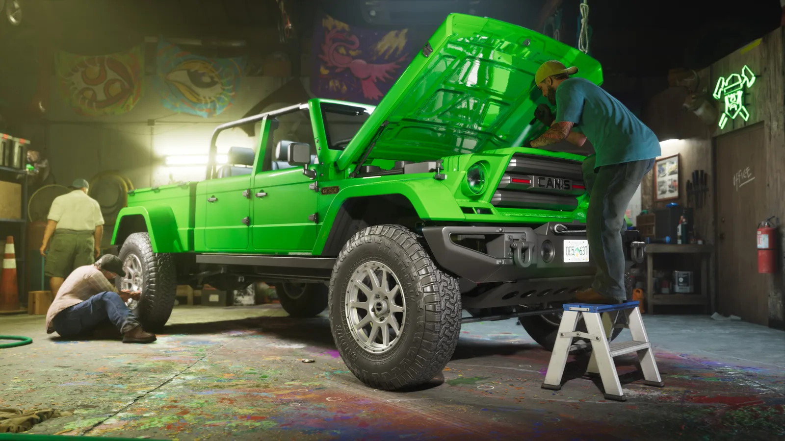 The bright green Canis pickup with its bonnet up in a paint-spattered workshop, one worker on a step stool leaning into the engine bay, another crouched at a front wheel and a third by the wall.