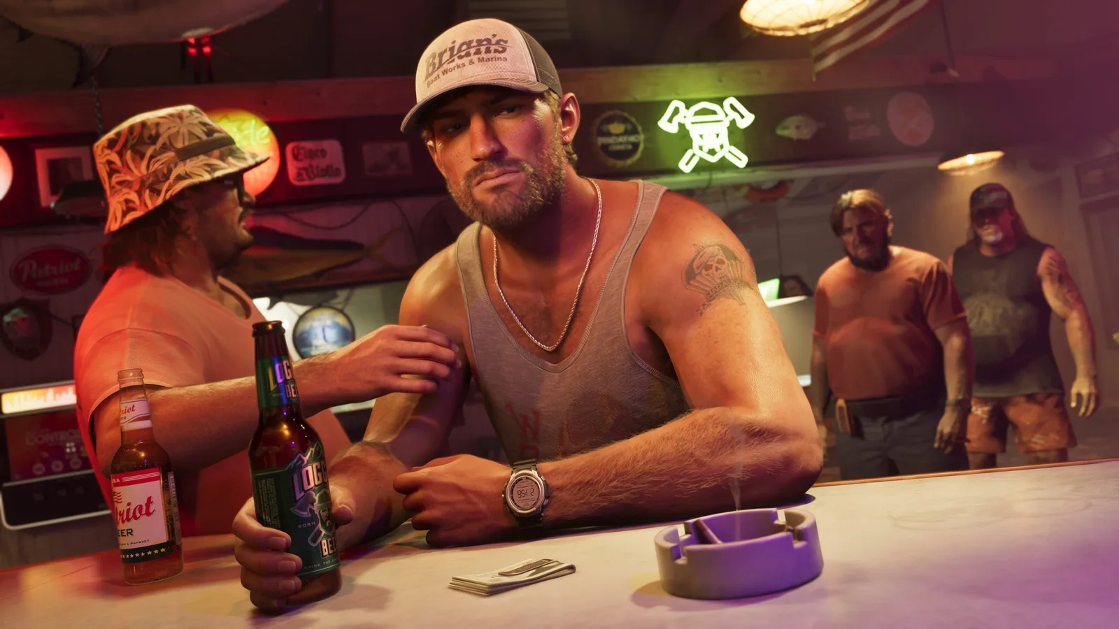 Jason Duval in a marina trucker cap and a white tank top leaning on a bar counter with a drink, another drinker in a floral bucket hat beside him and neon beer signs on the wall behind.