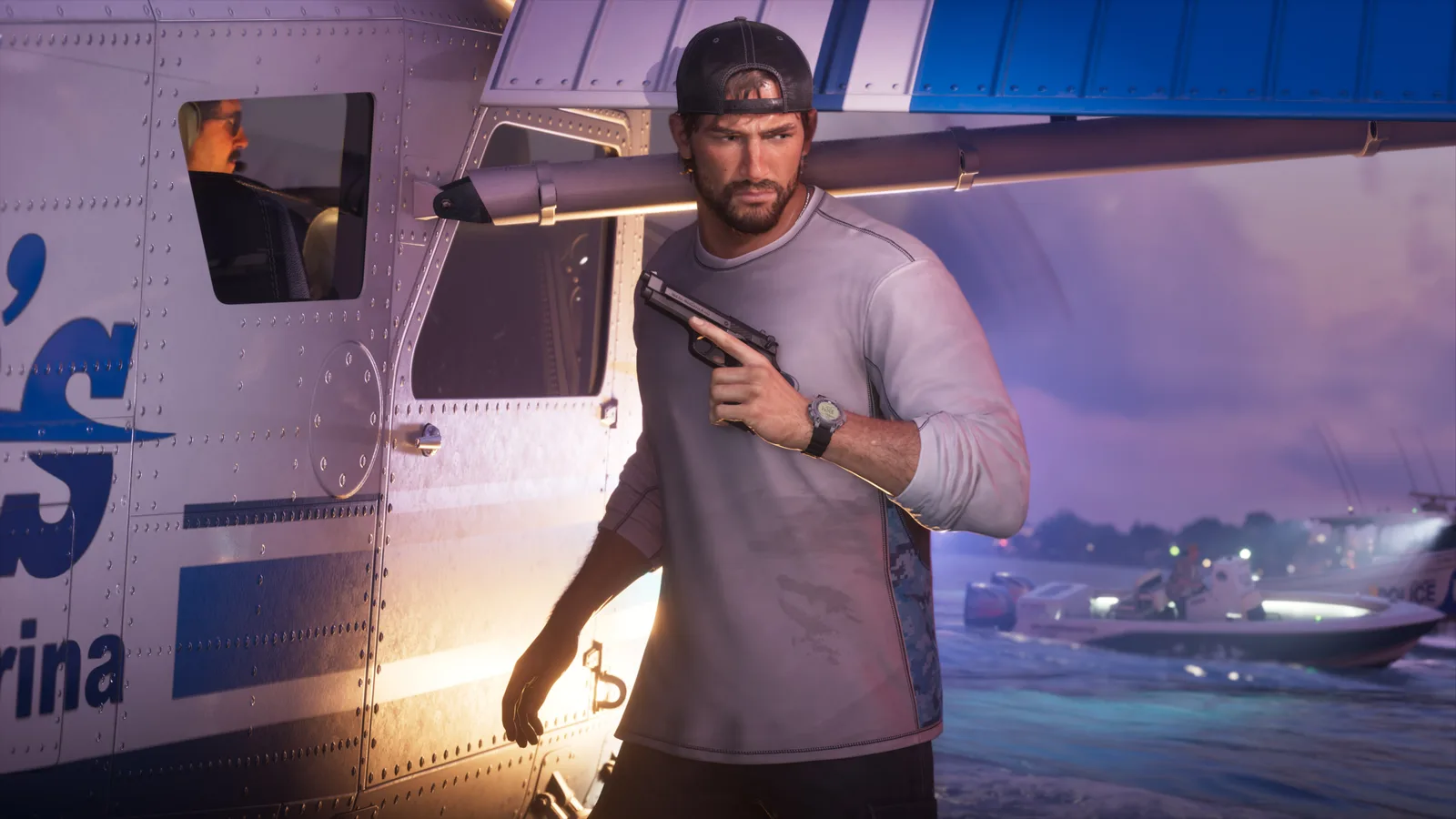 Jason Duval stepping out from behind the float of a seaplane at dusk with a pistol raised to his shoulder, a police boat idling on the water behind him.