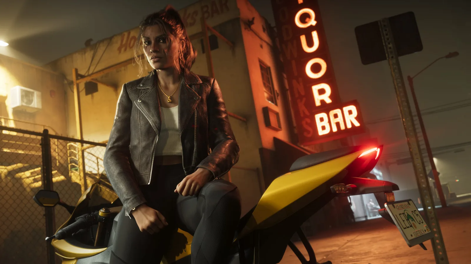Lucia Caminos in a leather jacket sitting astride a yellow motorcycle at night outside a bar, under a neon LIQUOR BAR sign.