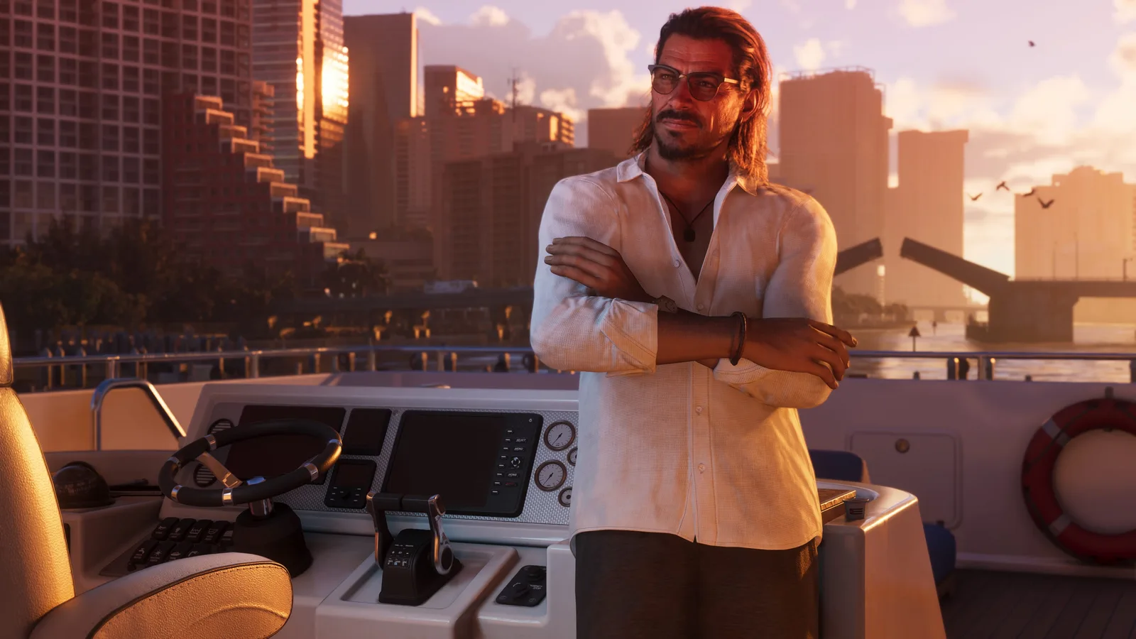 Raul Bautista standing with folded arms at the helm of a motor yacht at sunset, a city skyline and a raised drawbridge behind him.