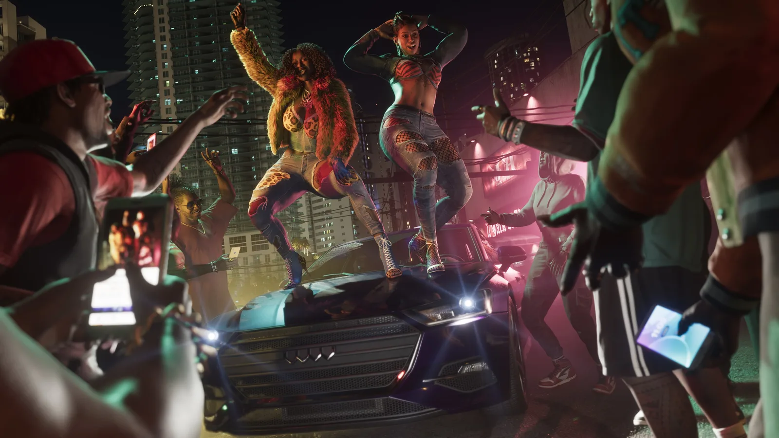 The two members of Real Dimez dancing on the hood of a car at night, one in a bright fur coat and one in ripped jeans, surrounded by a crowd filming on phones with tower blocks behind.