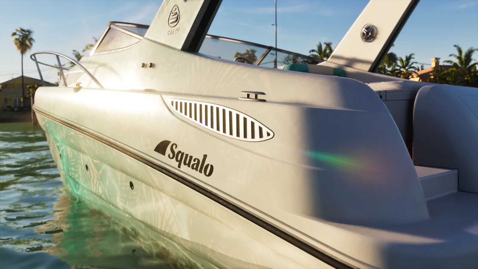 Close-up of the Squalo's white hull at the waterline in low sun, its Squalo and Shitzu badging catching the light, palms and a waterfront house behind.