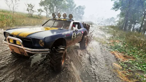 The mud-caked blue and yellow Vapid Dominator Buggy powering along a flooded dirt track on oversized off-road tires.